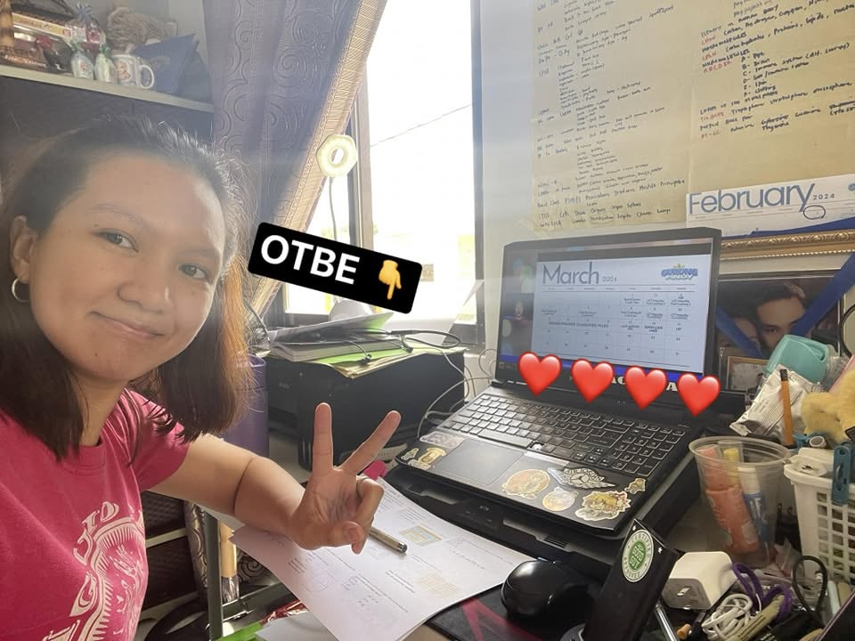 Rhonett Pucyutan Acorda Smiling at Desk with Laptop and Study Board - Outsmart the Board Exam Passer